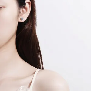S925 sterling silver four-claw moissanite stud earrings shown on model for women
