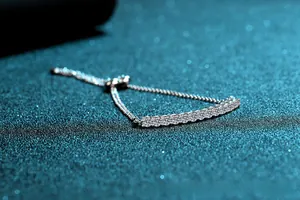 Detail of adjustable S925 silver bracelet with 1.3ct round moissanite row and pull clasp
