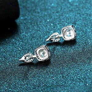 Macro view of 925 silver stud earrings with 4-prong moissanite and square halo setting