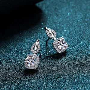 Elegant 925 sterling silver four-claw halo moissanite stud earrings on teal background