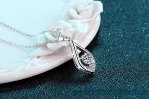 Macro detail of S925 silver teardrop necklace with sparkling moissanite diamond stone