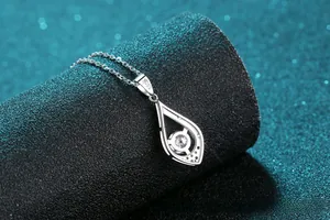 Macro shot of S925 sterling silver teardrop necklace with sparkling round diamond center