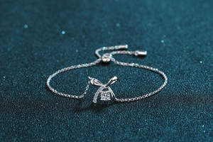 Macro detail of S925 sterling silver bow bracelet with sparkling moissanite and sliding clasp