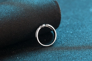 Close-up of S925 sterling silver ring with micro-pave crystals on a black textured stand