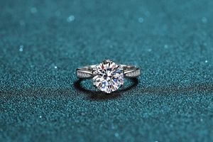 Macro shot of 3-carat moissanite ring with six-prong setting and side micro-pavé diamonds