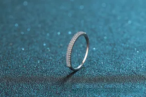 Macro side view of micro-pave moissanite stones on a slim S925 sterling silver band