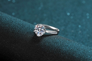 Macro detail of 3 carat moissanite ring with six-prong setting and pavé side stones