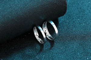 Nahaufnahme polierter S925 Sterlingsilber Ringe für Paare mit Moissanit auf blauem Grund