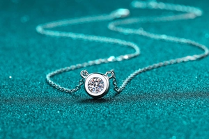 Macro detail of S925 sterling silver necklace with bezel-set brilliant moissanite stone