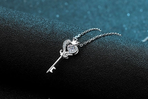 Macro detail of S925 sterling silver key pendant with sparkling heart crown diamond