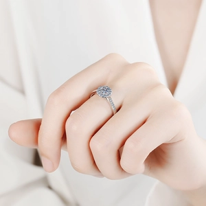 Classic S925 sterling silver halo ring with a round moissanite center stone on a hand