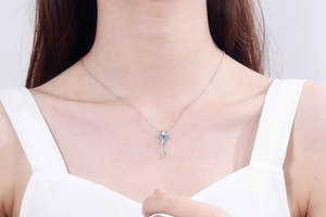 Close-up of S925 sterling silver key pendant necklace with a sparkling moissanite stone