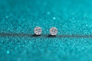 Macro shot of S925 sterling silver four-prong stud earrings with clear moissanite stones