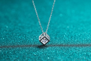 Macro view of a square hollow pendant necklace with a sparkling round moissanite stone