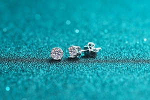 Macro shot of S925 silver four-prong stud earrings with brilliant round-cut moissanite stones