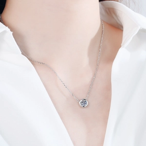 Minimalist S925 sterling silver necklace with a 1 carat moissanite round pendant on model