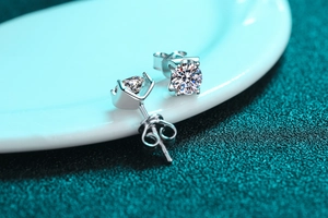 Macro shot of S925 sterling silver four-prong stud earrings with round moissanite