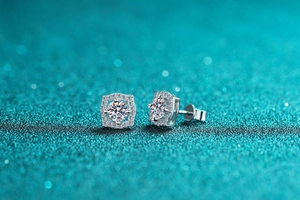 Macro shot of geometric S925 sterling silver halo stud earrings with round moissanite stones