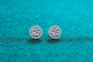 Macro detail of S925 sterling silver halo moissanite stud earrings with sparkling round cut stone