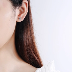 Elegant S925 sterling silver four-prong stud earrings with brilliant moissanite stone