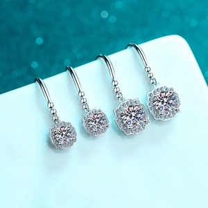 S925 sterling silver four-prong moissanite drop earrings in four sizes on blue backdrop