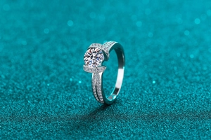 Detailed view of S925 silver ring featuring round moissanite and double row pavé setting