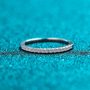 Elegant S925 sterling silver eternity band with sparkling moissanite stones on blue surface