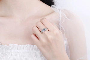 Classic silver S925 moissanite ring with round center stone worn on finger