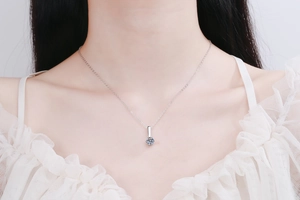 Gros plan d'un collier en argent sterling S925 et moissanite porté par une femme