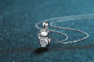 Macro shot of S925 silver lucky cat pendant with sparkling round moissanite stone