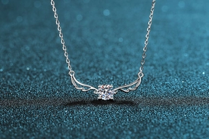 Macro view of S925 silver angel wing pendant with round brilliant-cut moissanite stone