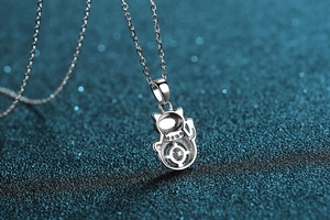 Macro shot of S925 silver cat astronaut pendant featuring a sparkling moissanite stone