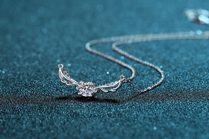 Macro shot of S925 silver angel wing necklace with a sparkling 0.5ct moissanite stone