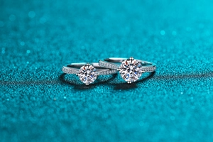 Macro shot of two S925 sterling silver moissanite rings with four-prong settings