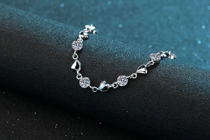 Macro shot of S925 sterling silver heart bracelet with sparkling round moissanite stones