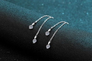 Macro detail of S925 sterling silver heart tassel earrings with round moissanite stones