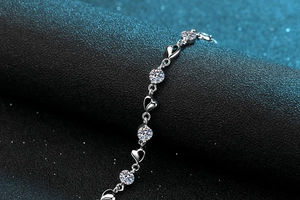 Macro shot of S925 sterling silver moissanite bracelet with heart links and round gems