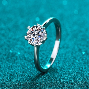 S925 sterling silver snowflake ring with 1 carat moissanite on blue bokeh background