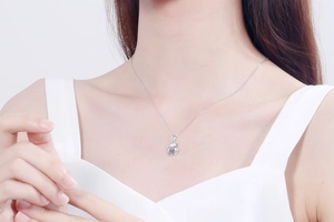 Close-up of S925 sterling silver necklace featuring a cute bear pendant with moissanite stone