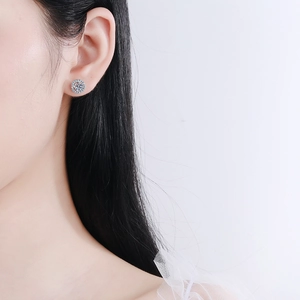 Halo Moissanite stud earrings in S925 sterling silver worn by a model on white background