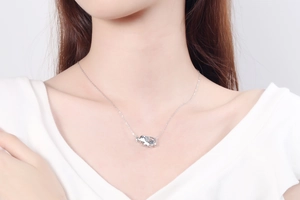 Detail of S925 sterling silver elephant pendant necklace with moissanite on neck
