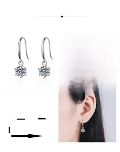 Close-up of six-prong moissanite earrings showing multi-layer plating and polished finish