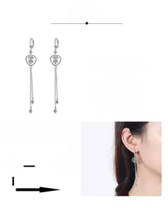 Detail of S925 sterling silver heart tassel earrings with moissanite and rhodium plating