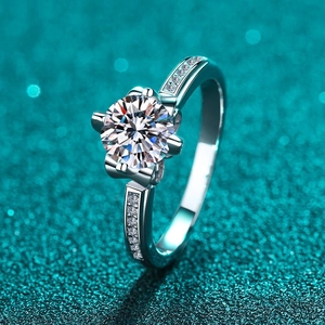 S925 sterling silver moissanite crown ring with classic six-prong setting on glitter background