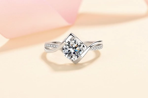 Macro shot of silver ring featuring twisted band and diamond-like stone in pavé setting
