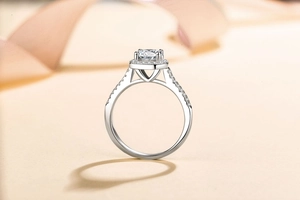 Macro shot of 925 silver halo ring with a round moissanite and pavé set diamonds