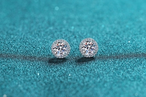 Macro shot of 925 silver halo earrings with brilliant-cut moissanite and pave stones