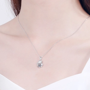Sterling silver lucky cat necklace with dancing stone on a female model's neck