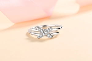 Macro shot of S925 sterling silver ring with X-shaped double band and sparkling stones