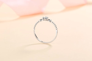 Detail view of S925 sterling silver ring featuring 4-prong moissanite and beaded texture